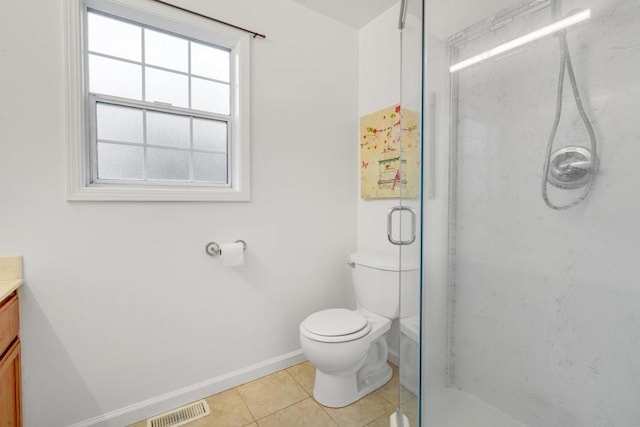 bathroom featuring vanity, toilet, a shower with door, and tile patterned flooring