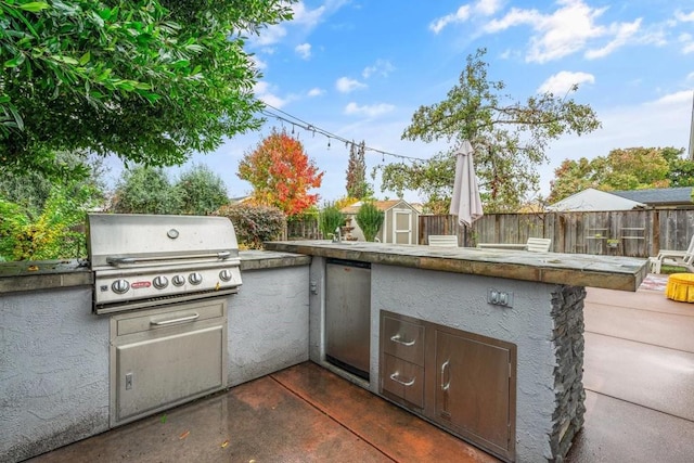 view of patio featuring exterior kitchen and grilling area