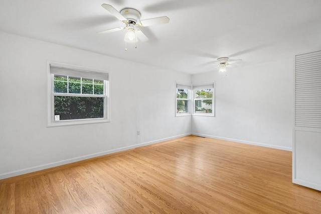 spare room featuring light hardwood / wood-style flooring and ceiling fan