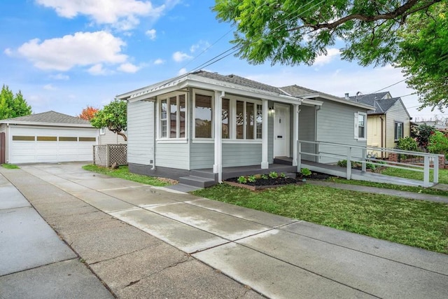 view of front of house with an outbuilding, a garage, and a front yard