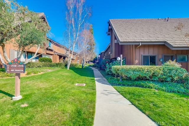 view of property's community with a yard