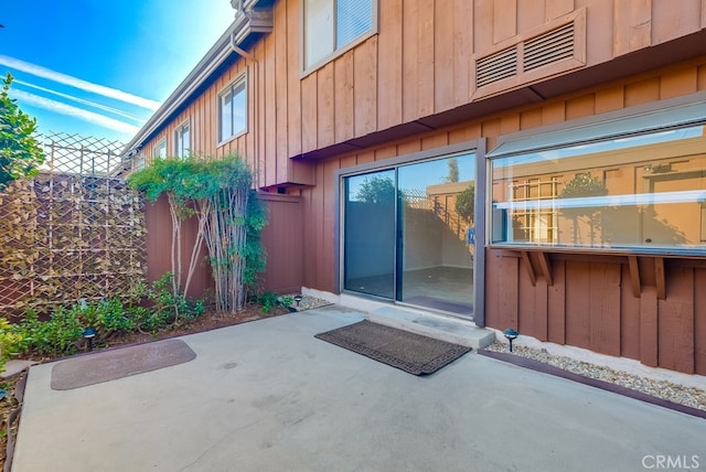 view of exterior entry featuring a patio