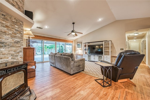 living room featuring light hardwood / wood-style floors, ceiling fan, and lofted ceiling