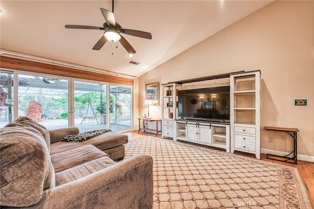 living room with hardwood / wood-style flooring, ceiling fan, and lofted ceiling