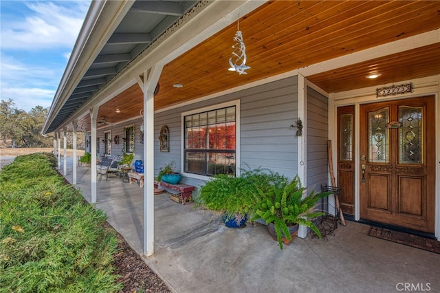 view of exterior entry with a porch