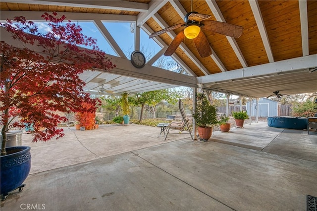 view of patio / terrace with ceiling fan and a shed