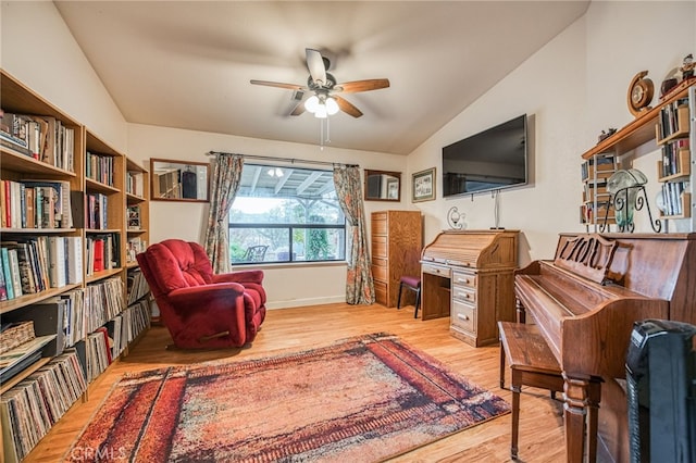 sitting room featuring light wood-type flooring, vaulted ceiling, and ceiling fan