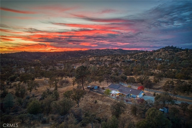 aerial view at dusk featuring a mountain view