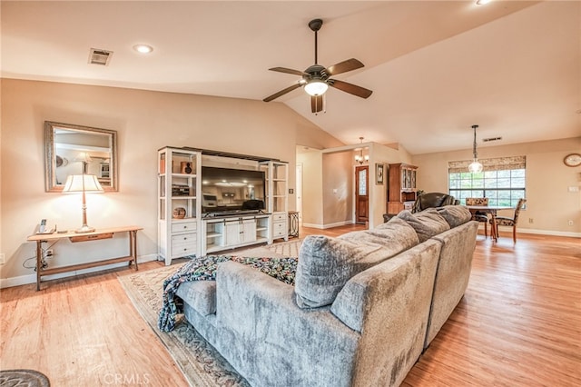 living room featuring hardwood / wood-style flooring, vaulted ceiling, and ceiling fan