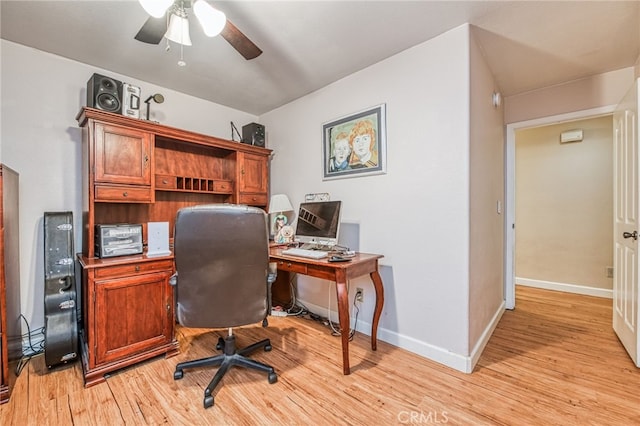 office area with light hardwood / wood-style floors and ceiling fan