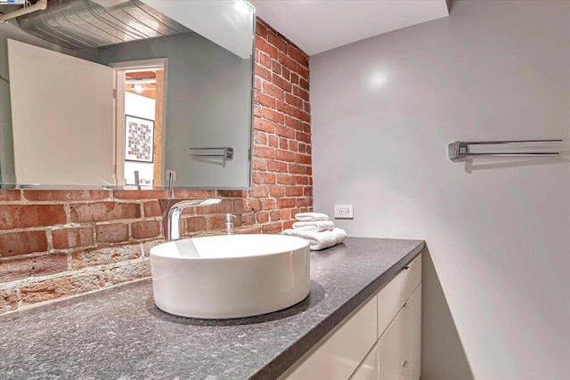 bathroom with vanity and tasteful backsplash