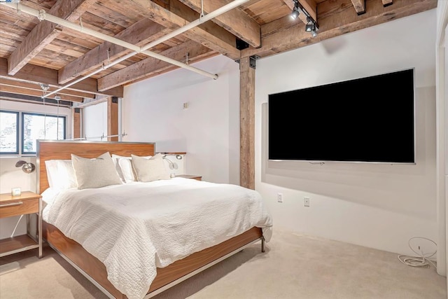 bedroom with carpet, beam ceiling, and wooden ceiling