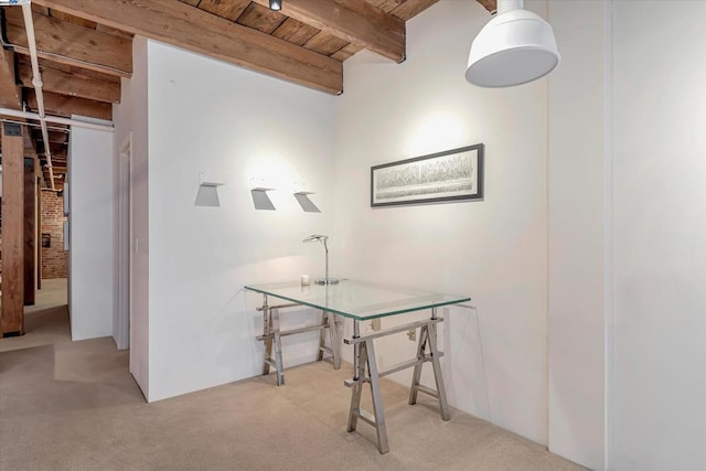 carpeted office space featuring beam ceiling and wooden ceiling