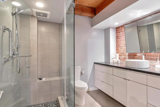 bathroom featuring tile patterned flooring, vanity, toilet, and walk in shower