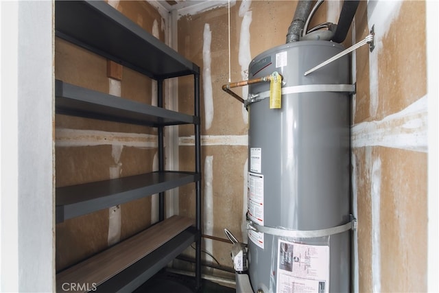 utility room featuring water heater