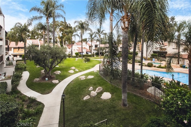 view of community with a pool and a yard