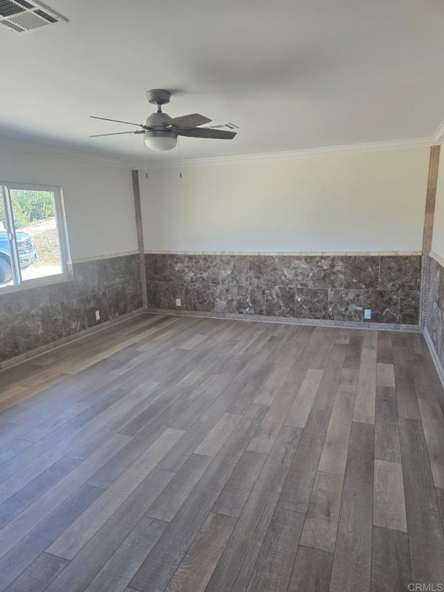 unfurnished room with ceiling fan, crown molding, and hardwood / wood-style flooring