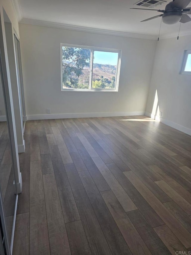 unfurnished room with ceiling fan, dark hardwood / wood-style floors, and ornamental molding