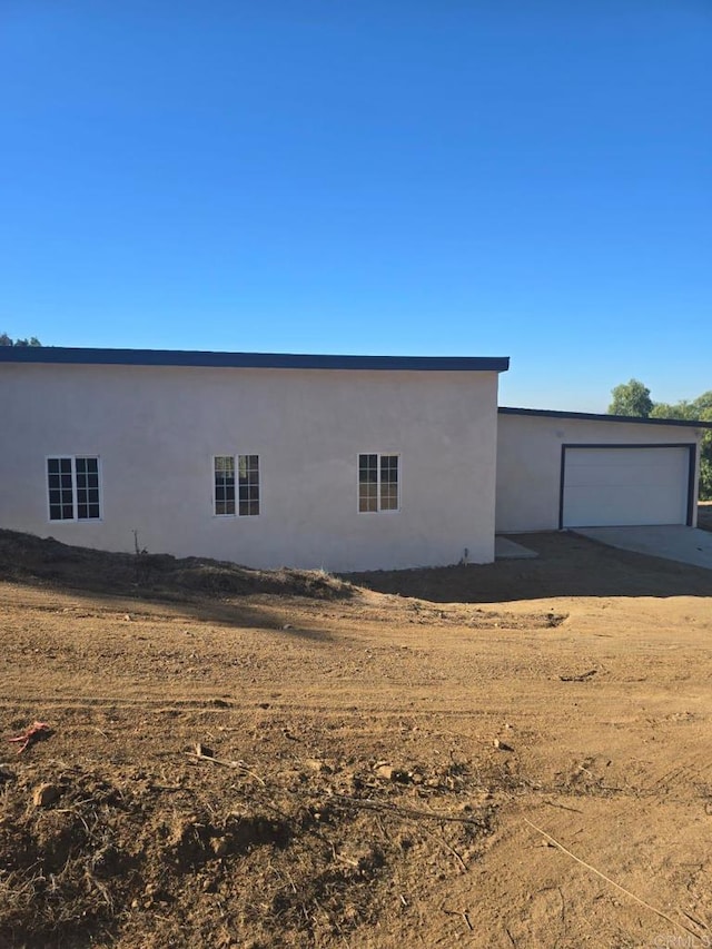 view of side of home featuring a garage