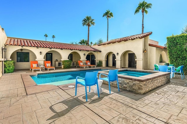 view of swimming pool with an in ground hot tub and a patio