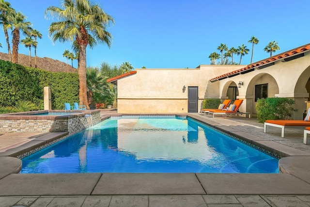 view of pool with an in ground hot tub and a patio