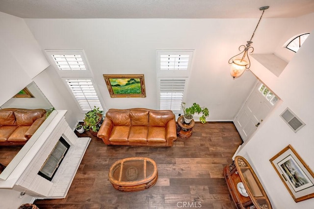 living area with wood finished floors and visible vents