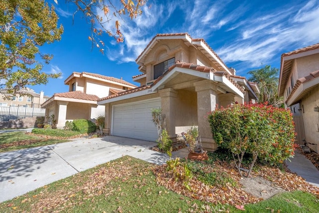 view of front of property featuring fence, stucco siding, concrete driveway, a garage, and a tile roof