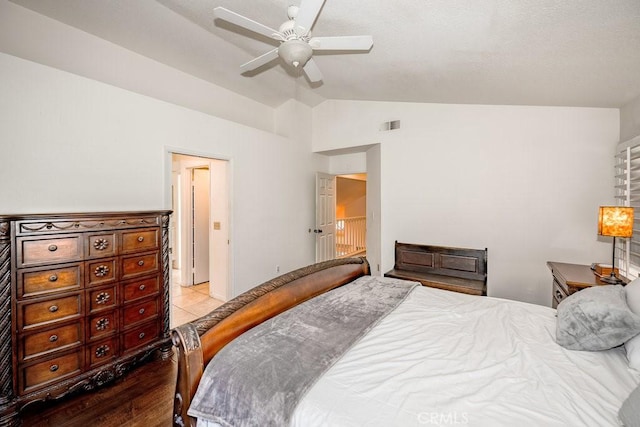 bedroom with visible vents, a ceiling fan, lofted ceiling, and wood finished floors