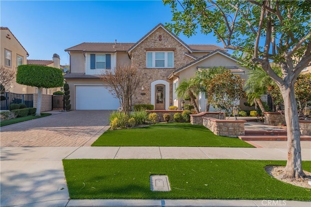 view of front of property with a front yard and a garage