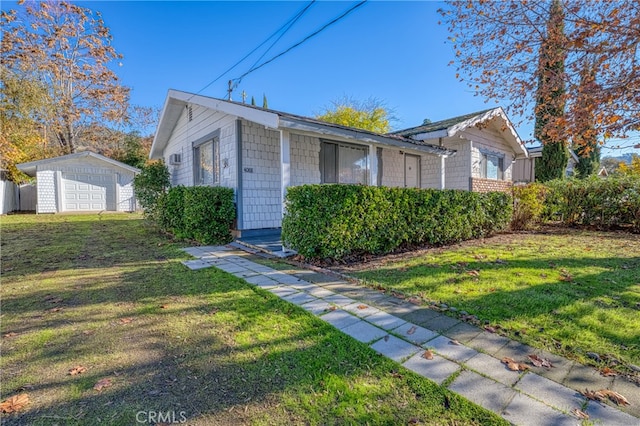 view of front of property with an outbuilding and a front yard