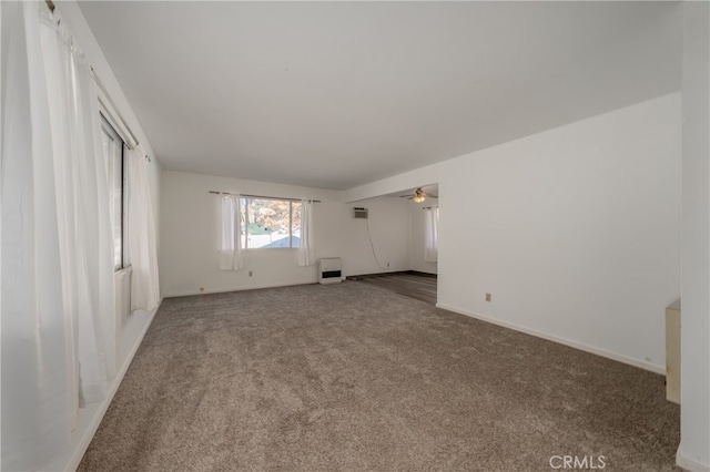 unfurnished living room with ceiling fan and carpet