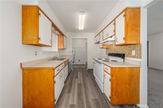 kitchen with white appliances, backsplash, wood-type flooring, sink, and white cabinetry