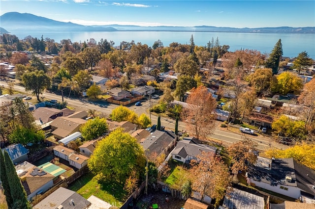 birds eye view of property featuring a water and mountain view