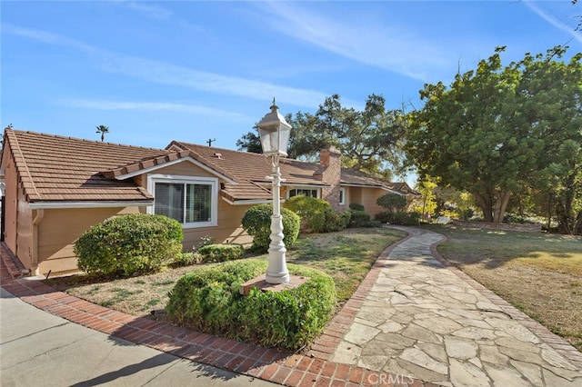 ranch-style home with a front lawn