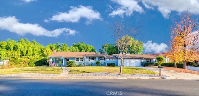 single story home with a front yard and a garage