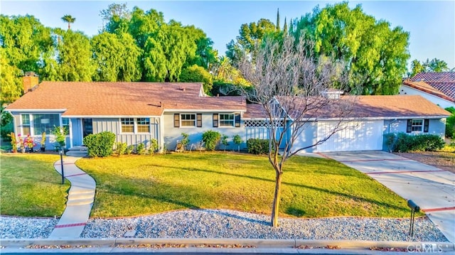 ranch-style house with a garage and a front lawn