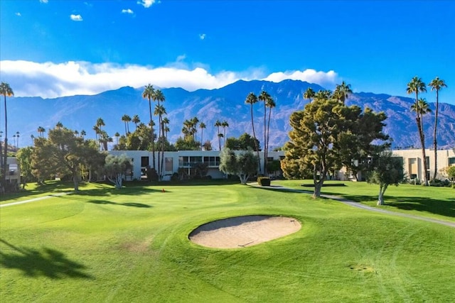 view of property's community with a lawn and a mountain view