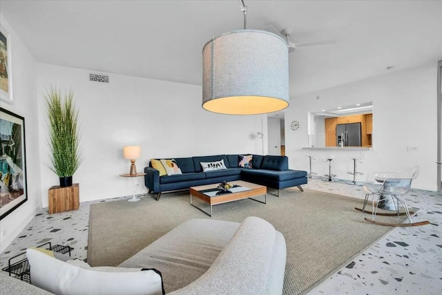 carpeted living room featuring ceiling fan