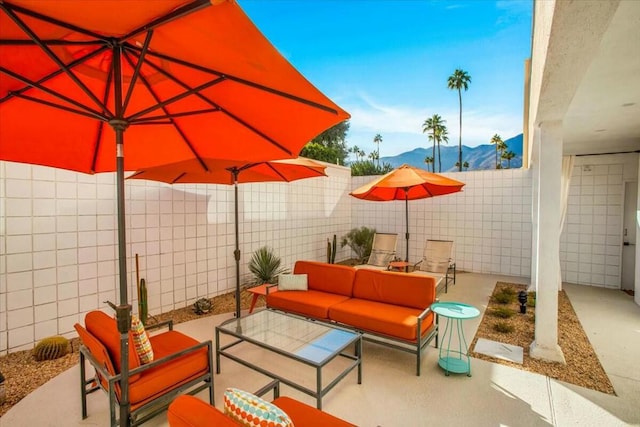 view of patio featuring an outdoor living space and a mountain view