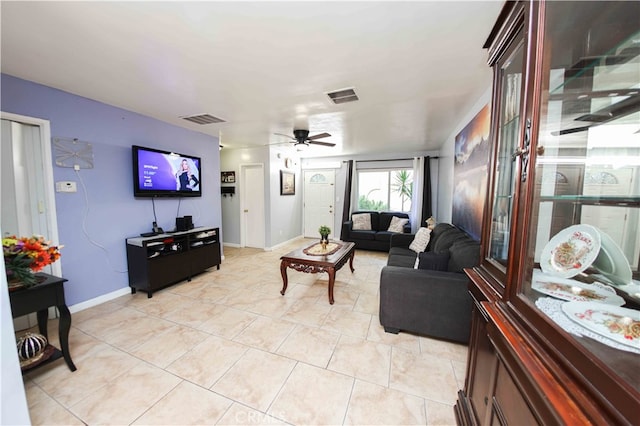 tiled living room featuring ceiling fan