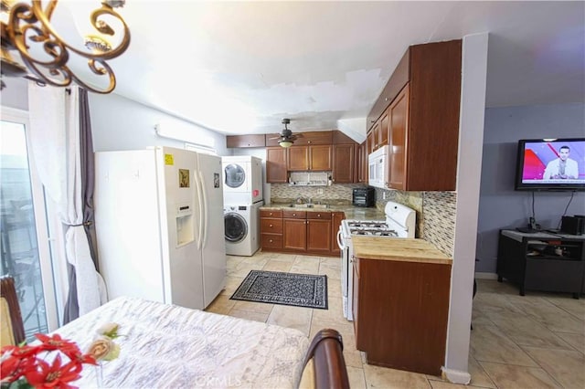 17053 Roscoe Blvd Unit 1, Northridge, CA 91325 - kitchen with white appliances, stacked washer / dryer, a ceiling fan, tasteful backsplash, and light tile patterned flooring