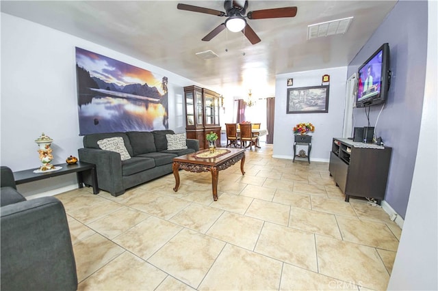 living room with ceiling fan and light tile patterned flooring