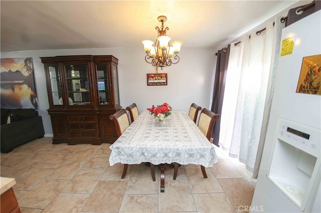 tiled dining space with a notable chandelier