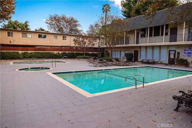 view of pool featuring a patio area and a community hot tub