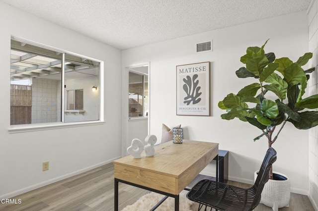 office area with hardwood / wood-style flooring and a textured ceiling