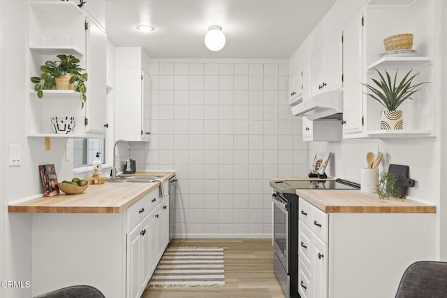 kitchen with white cabinets, wood counters, sink, and stainless steel appliances