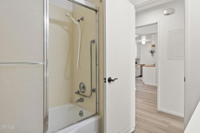 bathroom featuring combined bath / shower with glass door and wood-type flooring