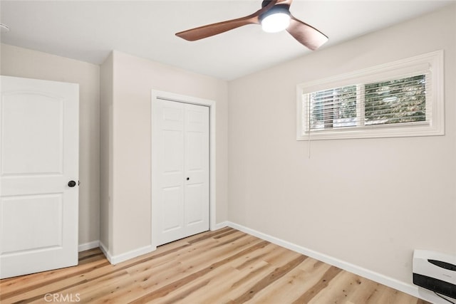 unfurnished bedroom with a closet, ceiling fan, and hardwood / wood-style floors