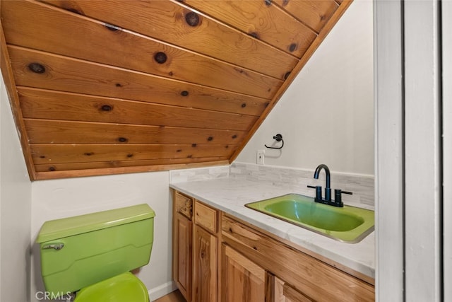 bathroom featuring vanity, wood ceiling, and lofted ceiling