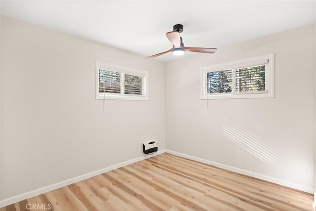 clothes washing area featuring ceiling fan, a healthy amount of sunlight, and hardwood / wood-style flooring